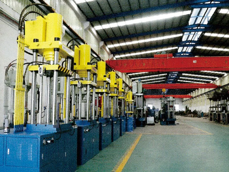 Row of hydraulic presses on the production floor