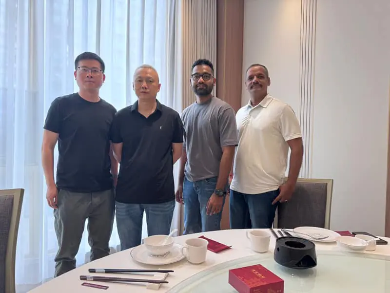Group standing beside a conference table during a facility visit