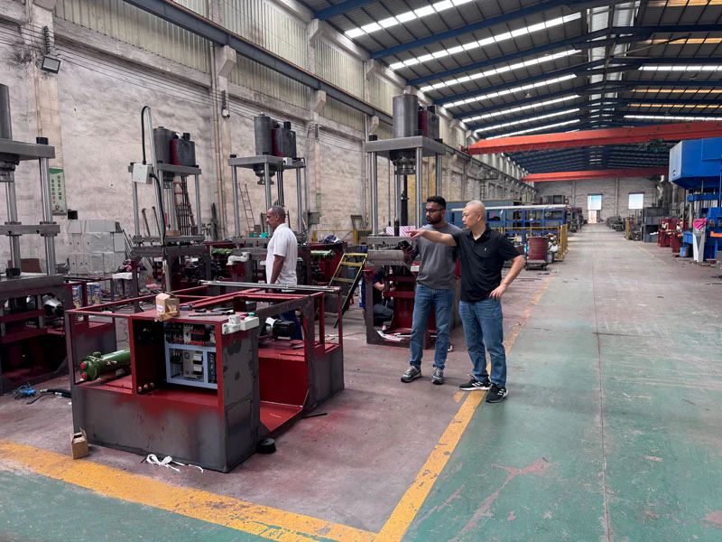 Group of people beside machines in a production workshop