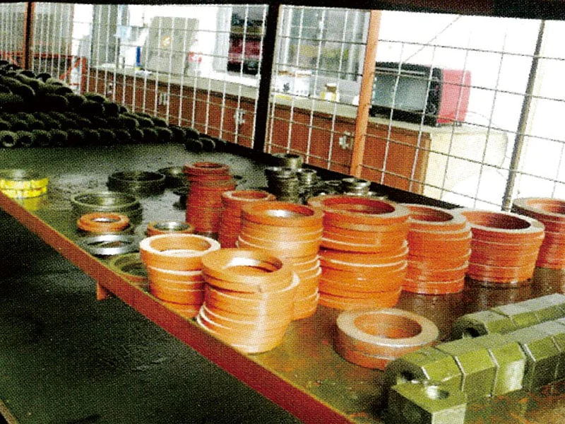 Copper-coloured metal rings and components on workshop shelves