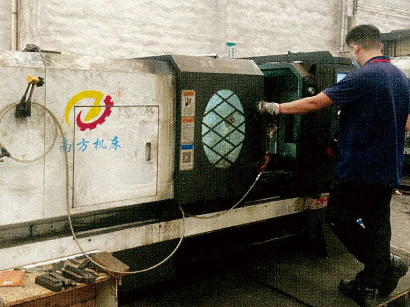 Operator working beside a large machining station